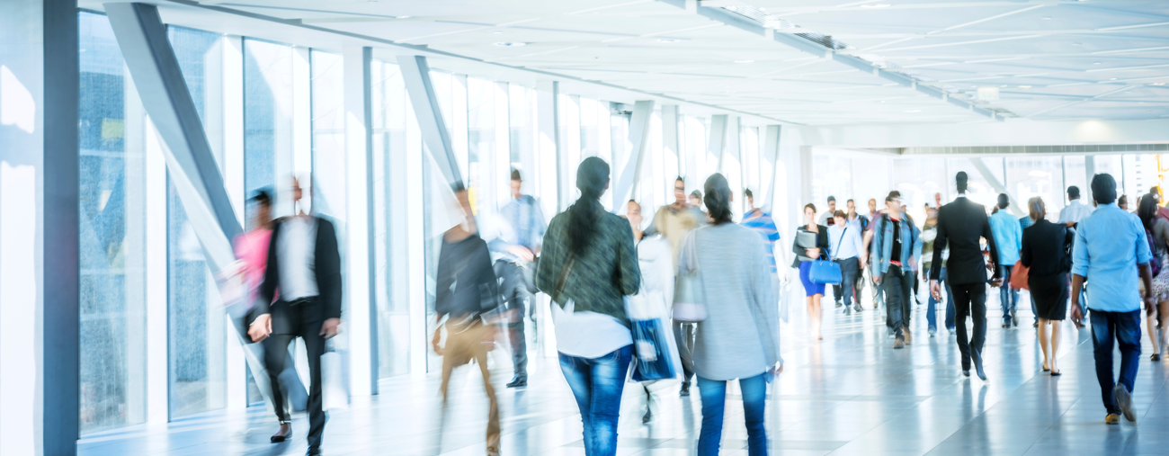 People walking through a bright sky bridge