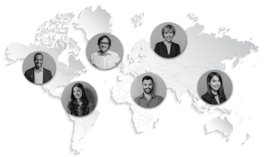 A white world map with black & white photos of staff in different countries