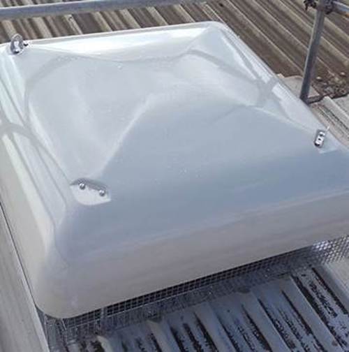 A photo of a horizontal discharge fan installed on the roof of a Scania work shop