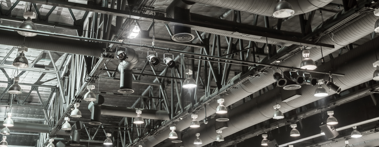 A photo showing an elaborate network of ducts used in a factory HVAC system.