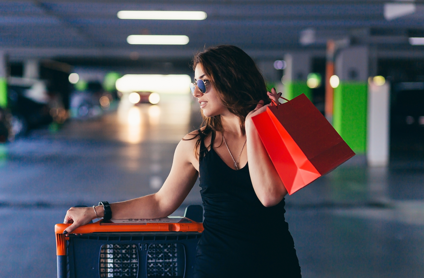 A stock photo of a woman walking through an underground parking garage