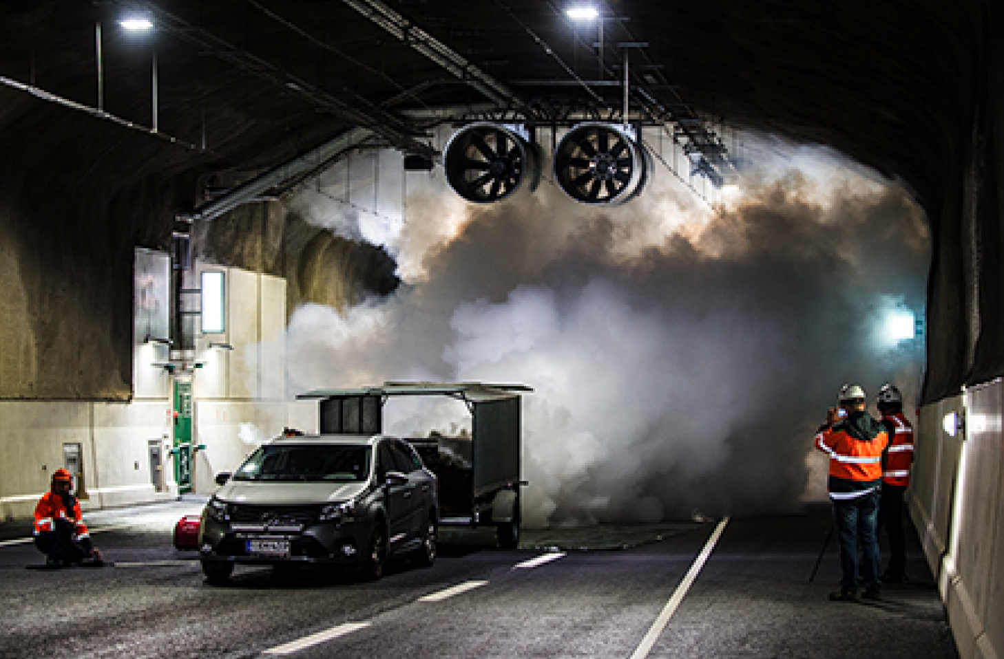 A photo of a jet fan test taking place in a smoky tunnel